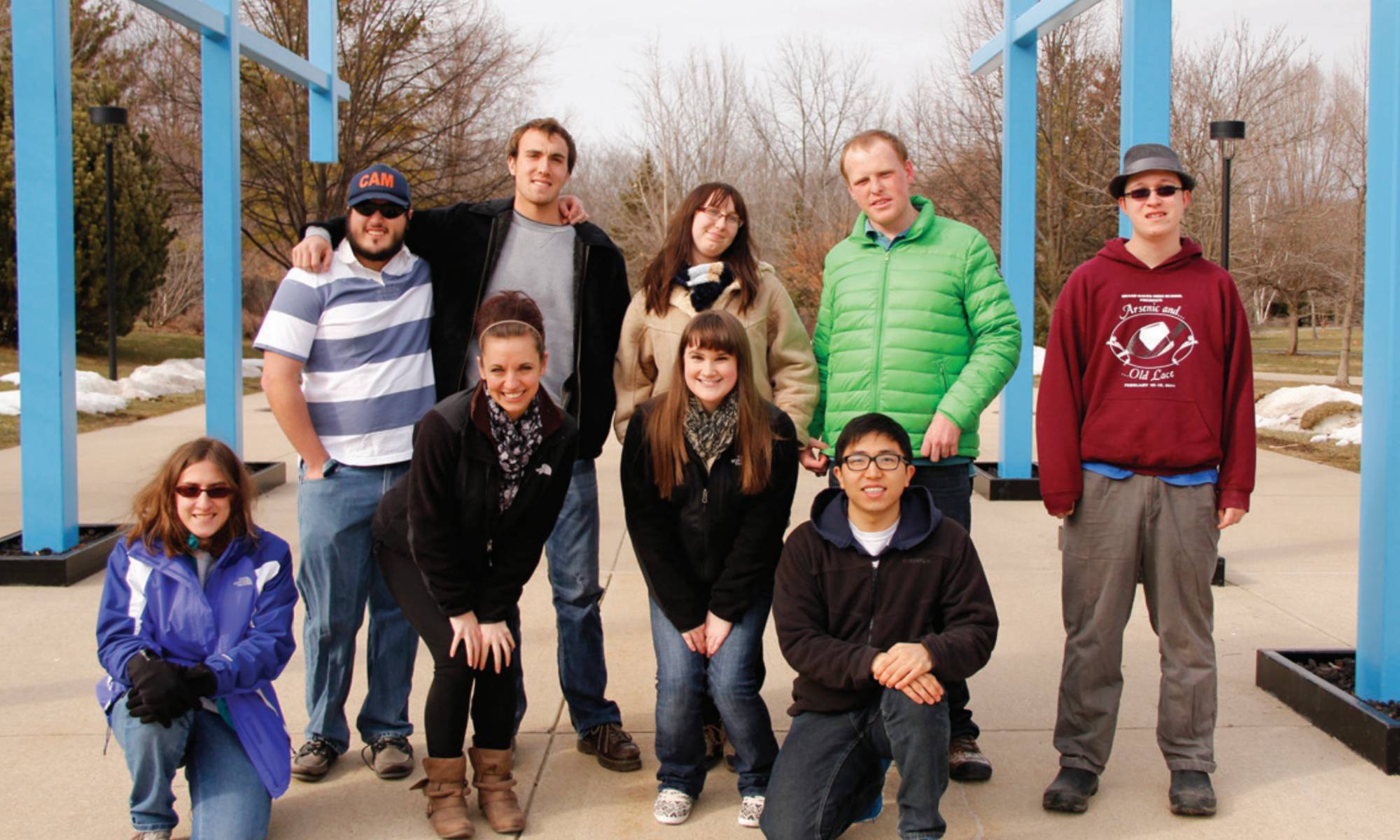 Group shot of campus links participants under the transformational link sculpture